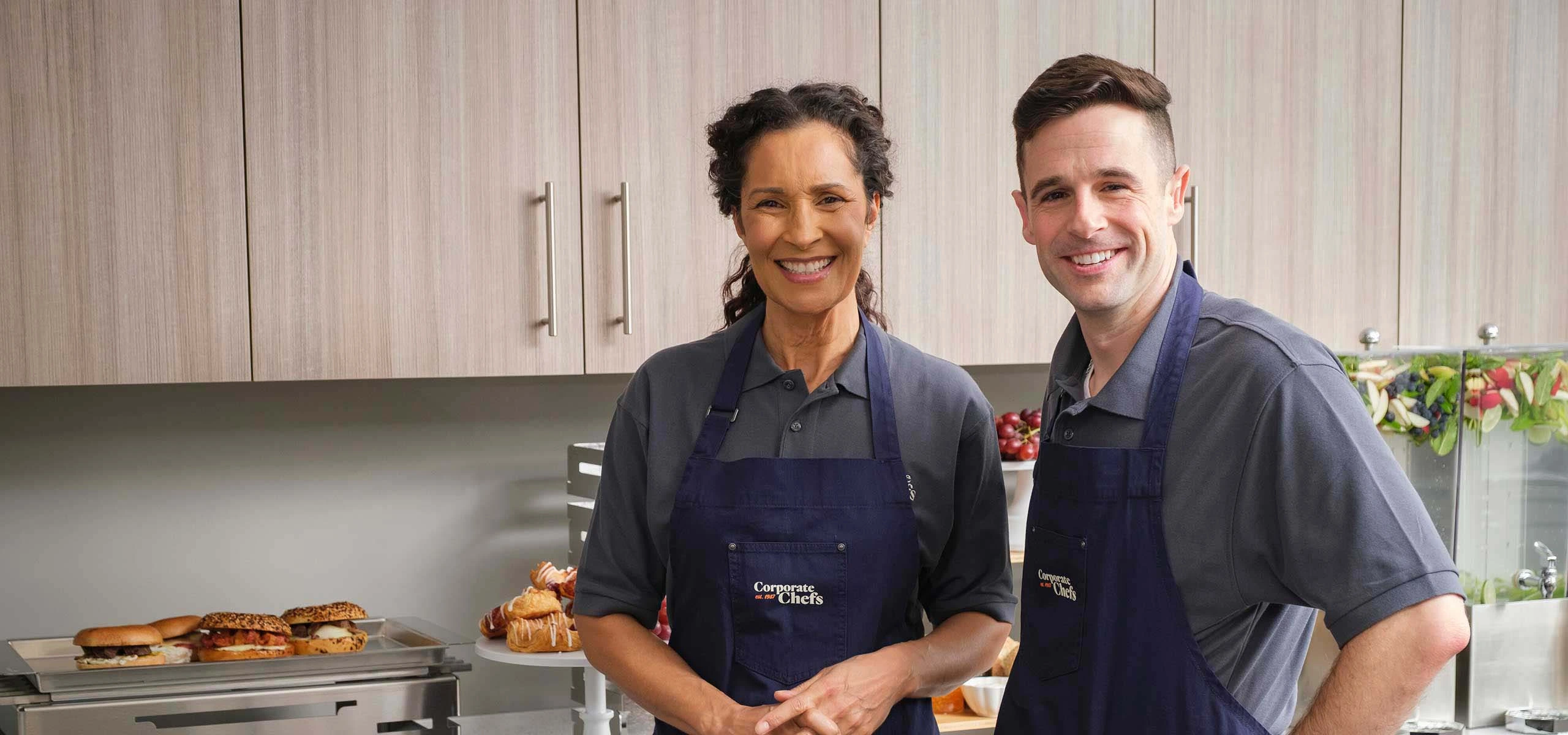 Two employees smiling at camera